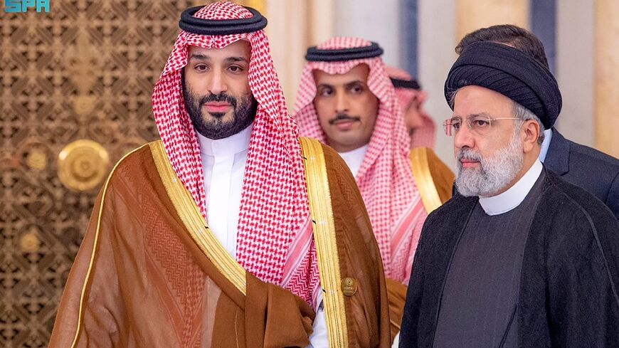 Saudi Crown Prince Mohammed bin Salman (L) walks with Iranian President Ebrahim Raisi at a November meeting of the Organisation of Islamic Cooperation on the war in Gaza