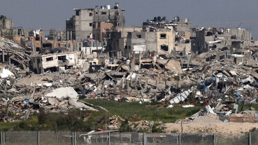 A view on March 28, 2024 from southern Israel of Gaza Strip buildings destroyed by Israeli strikes