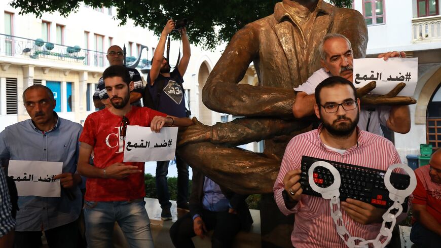 Activists gather to protest against a wave of interrogations by Lebanese security forces of people making political comments on social media, Beirut, July 24, 2018. The Arabic reads "Against oppression."