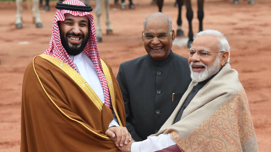 India's President Ram Nath Kovind (C) looks on as Saudi Crown Prince Mohammed bin Salman (L) and India's Prime Minister Narendra Modi shake hands during a ceremonial reception at the presidential palace in New Delhi on Feb. 20, 2019.
