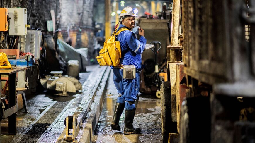 A miner from Gold Fields South Africa company walks near the exit of the South Deep gold mine in Westonaria, Gauteng, on Oct. 12, 2022.