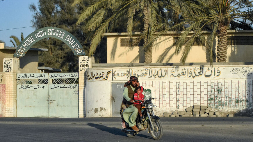 A motorcyclist rides past a high school at Panjgur district in Balochistan province on Jan. 17, 2024. Pakistan recalled its ambassador from Iran on Jan. 17, and blocked Tehran's envoy from returning to Islamabad after an Iranian air strike killed two children in the west of the country on Jan. 16.