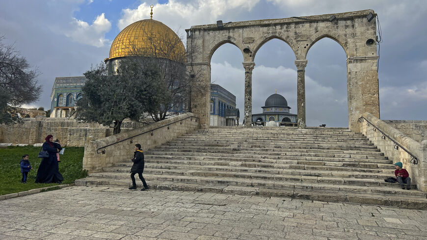 Palestinians walk past the Dome of the Rock at the compound of the Al-Aqsa mosque in the Old City of Jerusalem on Feb. 20, 2024.
