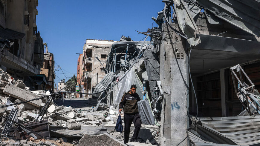 A Palestinian man walks through the rubble of a destroyed building due to Israeli bombardment in Rafah in the southern Gaza Strip on the second day of the Muslim holy fasting month of Ramadan on March 12, 2024, amid ongoing battles between Israel and the militant group Hamas. 