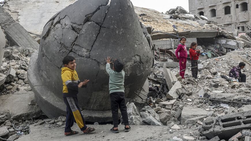 Children play in the rubble of Al-Faruq Mosque, which was destroyed during Israeli bombardment, in Rafah on the southern Gaza Strip on March 17, 2024. 