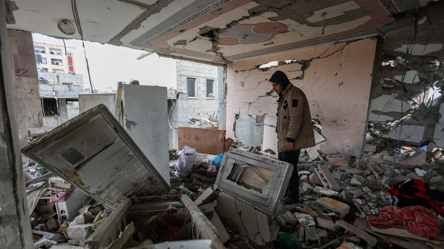 People inspect damage and recover items from their homes following Israeli air strikes on March 19, 2024, in Rafah, Gaza.