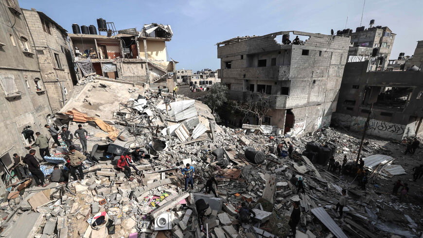 Palestinians check the rubble of buildings that were destroyed following overnight Israeli bombardment in Rafah, in the southern Gaza Strip, on March 27, 2024, amid the ongoing conflict between Israel and the Palestinian militant group Hamas. 