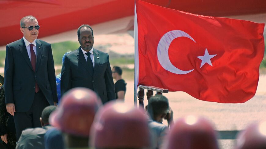 Turkish President Recep Tayyip Erdogan ( L) stands beside Somali President Hassan Sheikh Mohamud upon his arrival at the Aden Abdulle international airport in Mogadishu on Jan. 25, 2015.