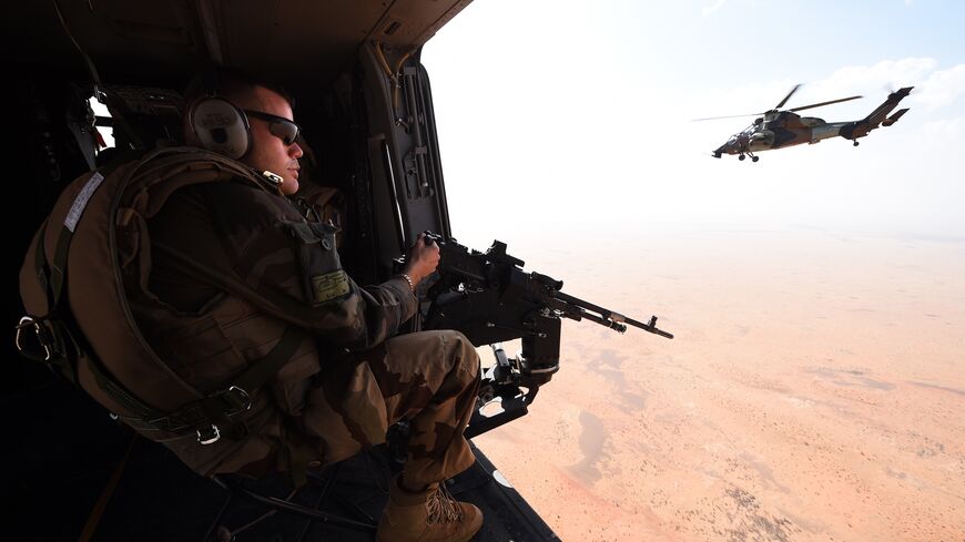 A French soldier of the operation Barkhane, an anti-terrorist mission in Sahel, patrols as a tiger helicopter operates a tactical flight on March 12, 2016 in Mali. France's Barkhane counter-terror mission comprises at least 3,500 soldiers deployed across five countries (Mauritania, Mali, Niger, Chad and Burkina Faso) with a mandate to combat jihadist insurgencies in the region. 