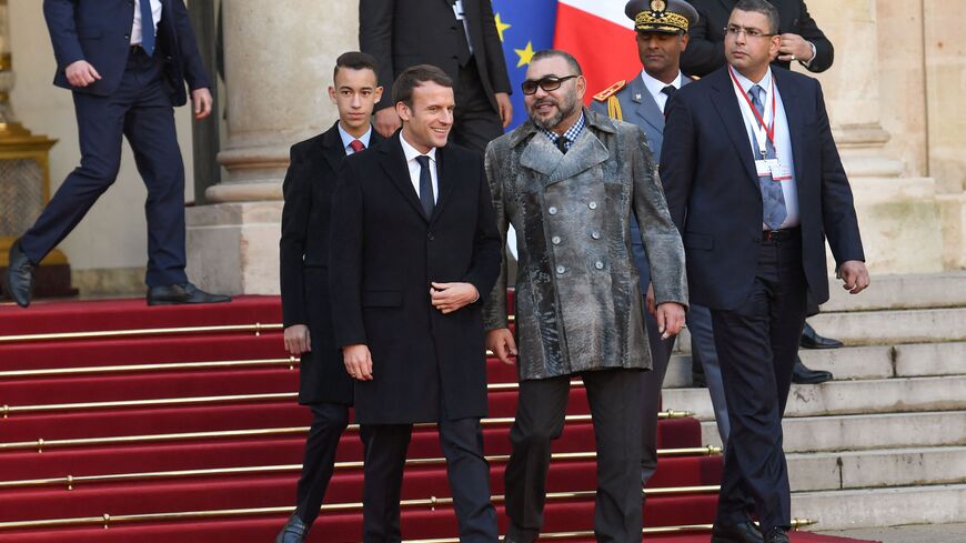 French President Emmanuel Macron (L) escorts King Mohammed VI of Morocco (C) and Crown Prince of Morocco, Moulay Hassan as they leave the Elysee palace on December 12, 2017 in Paris, following a lunch hosted by the French President as part of the One Planet Summit. The French President hosts 50 world leaders for the "One Planet Summit", hoping to jump-start the transition to a greener economy two years after the historic Paris agreement to limit climate change. (Photo by ALAIN JOCARD / AFP) (Photo by ALAIN 
