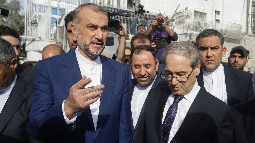 Iran's Foreign Minister Hossein Amir-Abdollahian (L) with his Syrian counterpart Faisal Mekdad (R) on the site of the new consular section