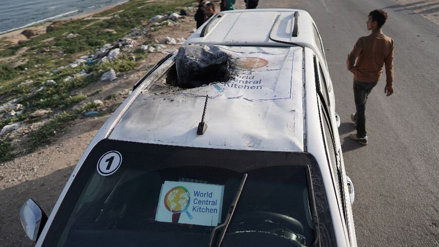 The roof of a charred vehicle with the group's logo shredded by the impact of the strike