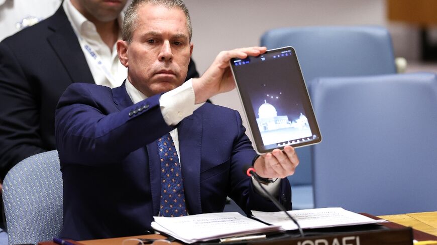 Israeli Ambassador to the UN Gilad Erdan shows a video of drones and missiles heading toward Israel during a United Nations Security Council meeting on the situation in the Middle East at UN headquarters in New York City on April 14, 2024