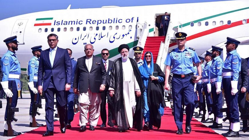 Iranian President Ebrahim Raisi (C) arrives in Islamabad for talks with Pakistani leaders on Monday