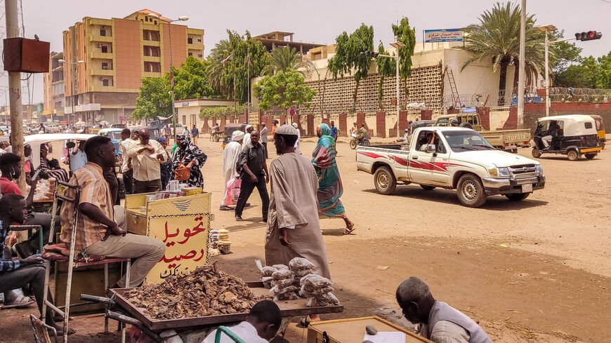 Pedestrians and vehicles move along a road outside a branch of the central bank, in the eastern city of Gedaref, Sudan, July 9, 2023.