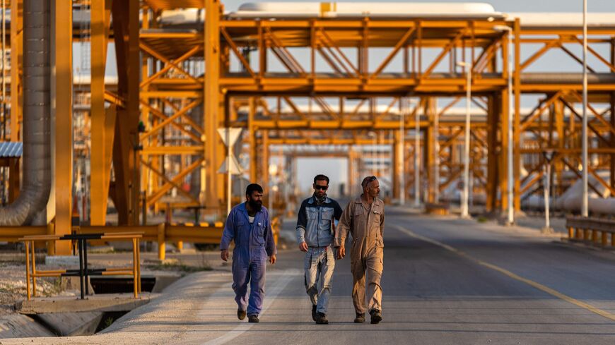 Workers walk along at refinery No. 2 (Phases 2, 3) of the South Pars Gas-Condensate field.