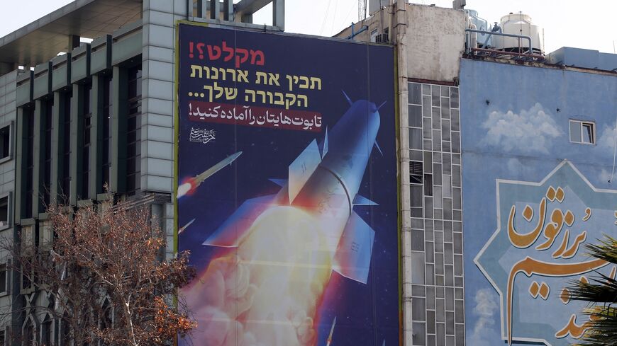 A large billboard depicting Iranian missiles with writing in Hebrew and in Persian, which reads "prepare your coffins," hangs on the side of a building in Tehran on Jan. 16, 2024, after Iran's overnight missile attacks on multiple targets in Syria and in Iraq's autonomous Kurdistan region. 