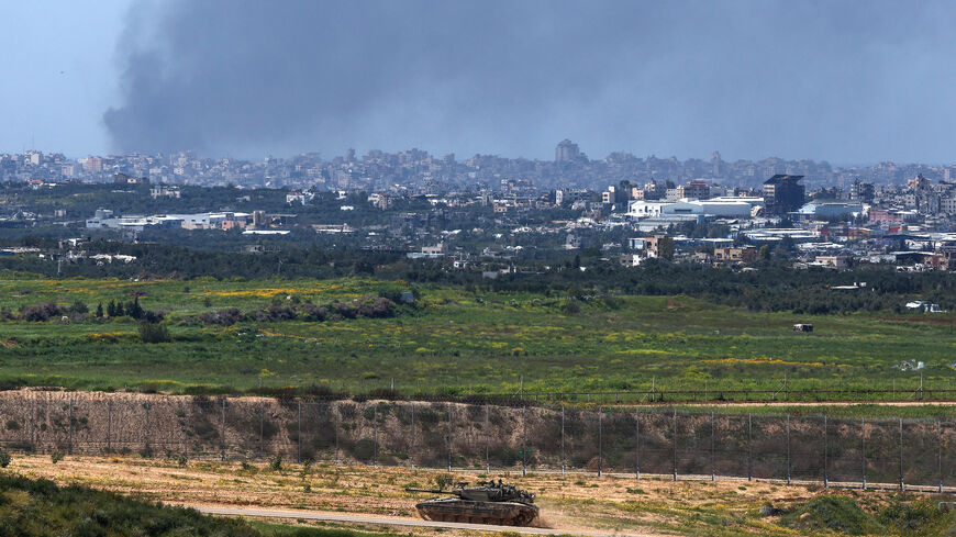 This picture taken from Israel's southern border with the Gaza Strip shows an Israeli tank moving along the border with the Palestinian territory on March 20, 2024, amid the ongoing conflict between Israel and the militant group Hamas. 