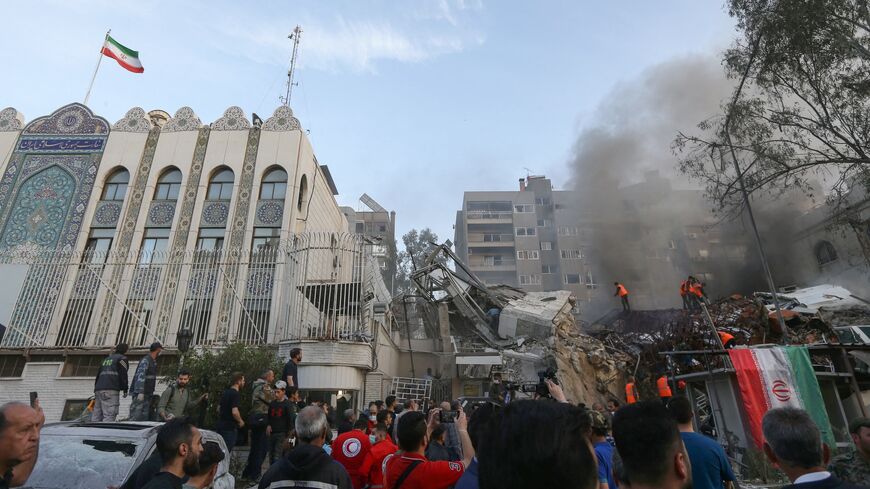 Emergency and security personnel search the rubble at the site of strikes which hit a building annexed to the Iranian embassy in Syria's capital Damascus, on April 1, 2024. 