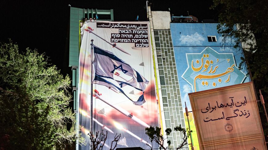 A view of an anti-Israel mural illustrates appreciation for the IRGC attack on Israel with text in Persian reading "The next slap will be stronger" and in Hebrew "Your next mistake will be the end of your fake country." 