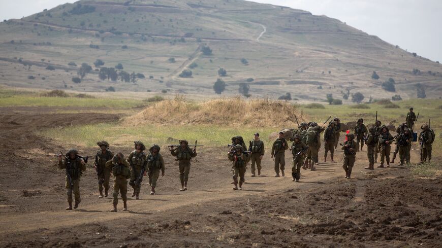 Israeli soldiers of the Jewish Ultra-Orthodox battalion "Netzah Yehuda" take part in their annual unit training in the Israeli annexed Golan Heights, near the Syrian border on May 19, 2014. The Netzah Yehuda Battalion is a battalion in the Kfir Brigade of the Israel military which was created to allow religious Israelis to serve in the army in an atmosphere respecting their religious convictions. AFP PHOTO/MENAHEM KAHANA (Photo credit should read MENAHEM KAHANA/AFP via Getty Images)