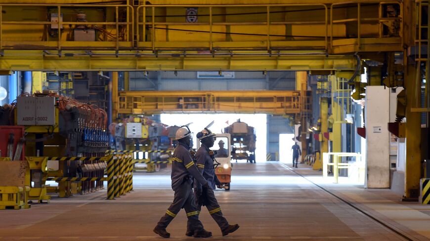 Emloyees walk inside the Maaden Aluminium Factory in Ras Al-Khair Industrial area near Jubail City, 570 kms east of the Saudi capital Riyadh, on November 23, 2016.