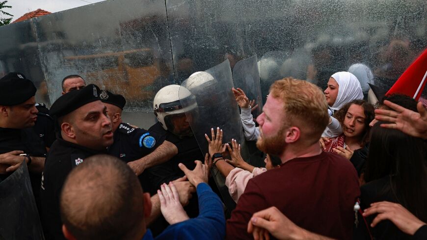 Palestinian Authority police prevent demonstrators from reaching the Canadian Representative Office in Ramallah in the occupied West Bank on April 30, 2024