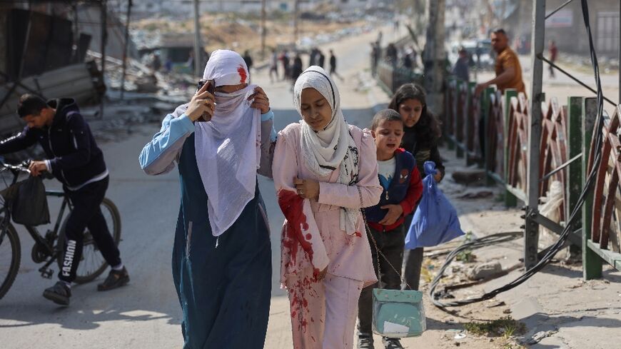 A family accompanies an injured Palestinian girl following Israeli bombardment on the Firas market area of Gaza City 