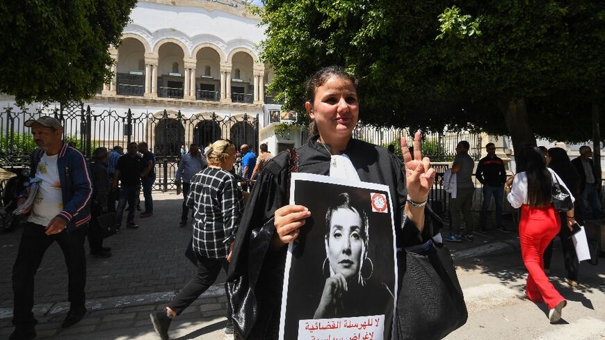 Lawyers carrying placards rally in front of the Tunis Court on May 13, 2024 