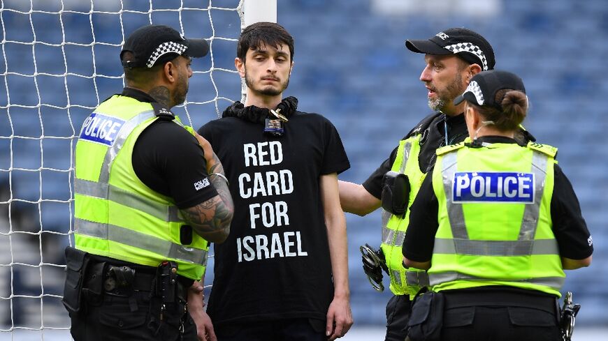 Delay: A demonstrator wearing a T-shirt with the slogan 'Red card for Israel' chained himself to a goalpost prior to the UEFA Women's Euro 2025 qualifier between Scotland and Israel in Glasgow
