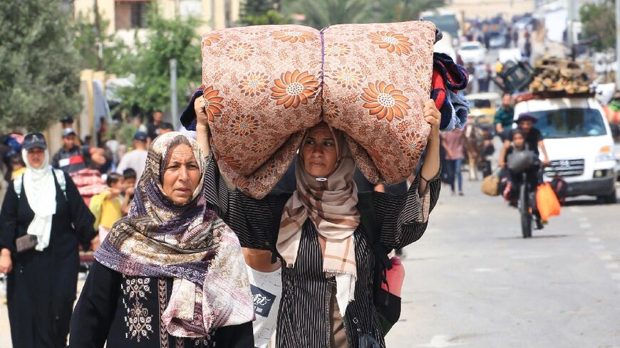 Palestinians fleeing the Tal al-Sultan area of Rafah with their belongings
