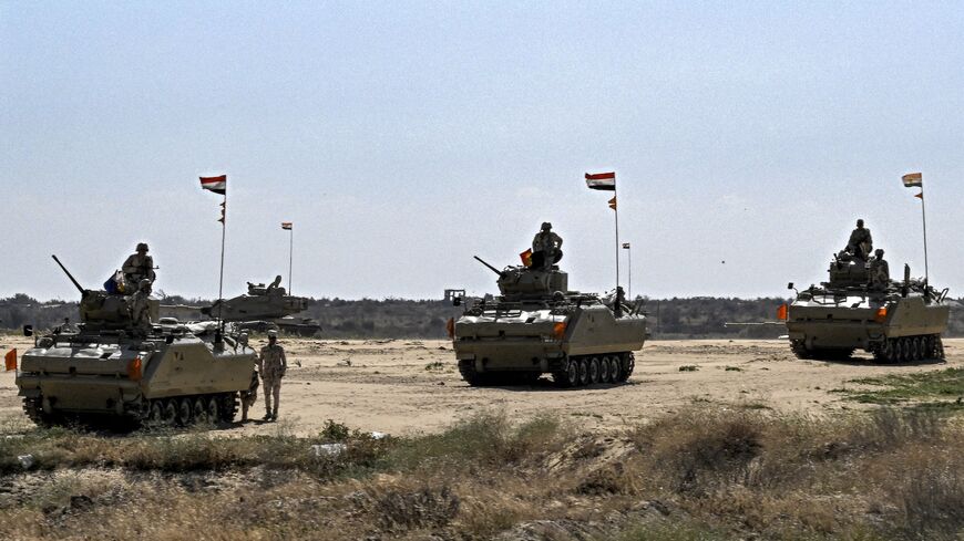 Egyptian army infantry fighting vehicles (IFV) are deployed near the Egyptian side of the Rafah border crossing with the Gaza Strip on March 23, 2024, amid the ongoing conflict in the Palestinian territory between Israel and the Palestinian militant group Hamas. 