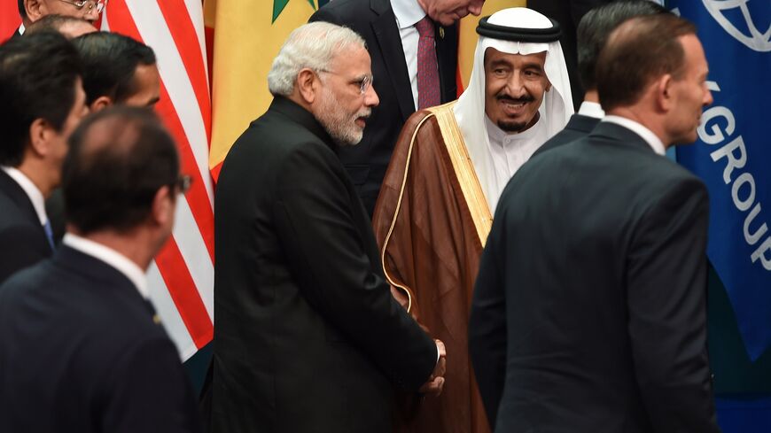 Saudi Arabia's Crown Prince Salman bin Abdulaziz (2nd R) shakes hands with India's Prime Minister Narendra Modi (C) after they joined heads of states and international organizations for a "family photo" during the G20 Summit in Brisbane on Nov. 15, 2014. 