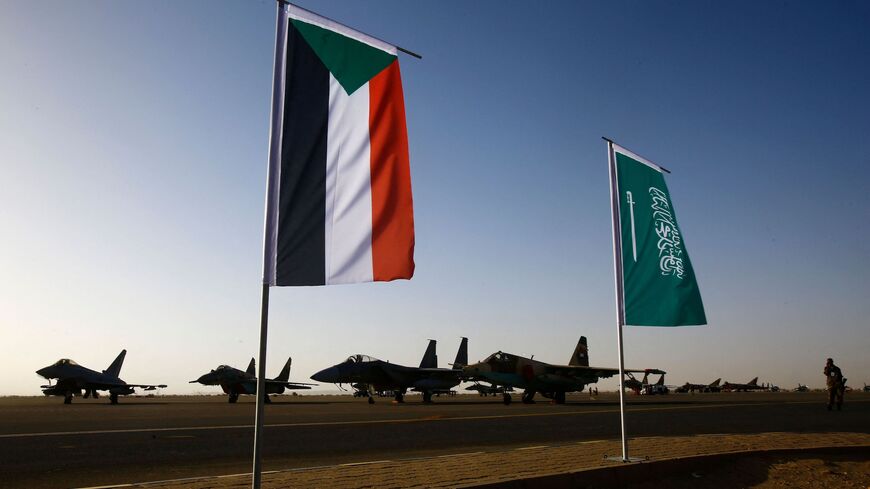 The Sudanese (L) and Saudi flag are seeing flying on the tarmac during a joint Sudan and Saudi Arabia air force drill at the Marwa air base, near Meroe some 350 kilometres north of Khartoum, on April 9, 2017.