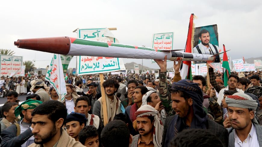 Demonstrators carry a mock missile during a pro-Palestinian and anti-Israel rally in Yemen's Huthi-held capital Sanaa on April 26
