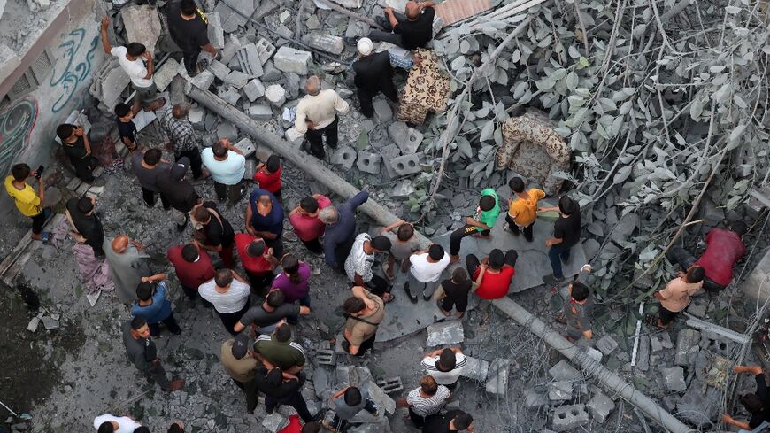 Palestinians search for survivors after a strike on the Al-Daraj neighbourhood in Gaza City