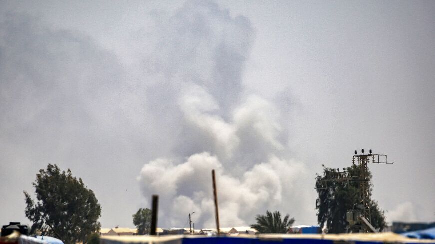 Smoke plumes billow near tents sheltering displaced Palestinians in Rafah in the southern Gaza Strip on June 4, 2024 