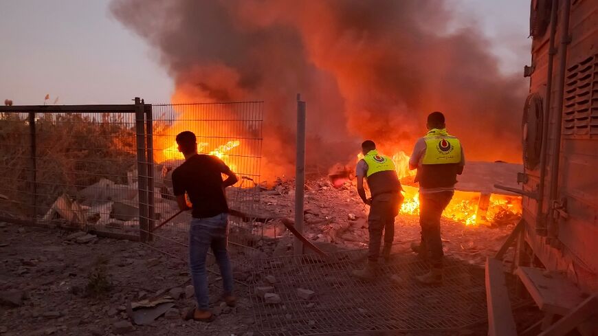 Rescuers rush to the scene of an Israeli airstrike that targeted the southern Lebanese village of Abbasiyeh on September 24, 2024