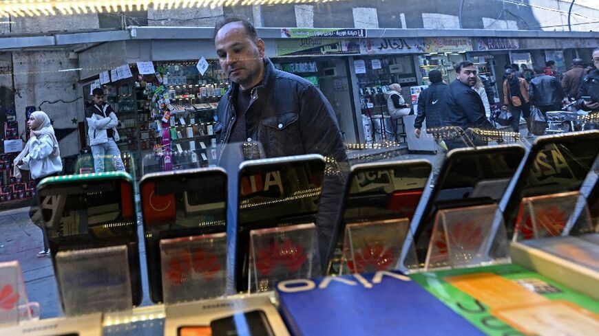 Security forces used to regularly raid a Damascus district where many phone stores operate to enforce an Assad-linked company's monopoly