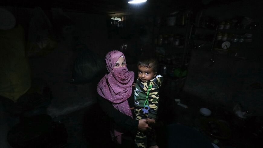A woman and her baby in a tent at the Atme camp for displaced people in northwest Syria