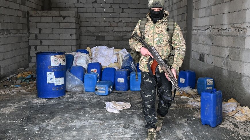 A member of the Syrian security forces searches a defunct drug factory inside an abandoned building in the countryside of Qusayr, at the porous Lebanese border