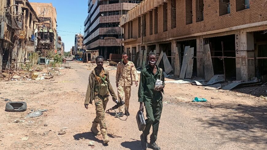 Fighters loyal to the Sudanese army patrol a street in Khartoum on March 24, 2025