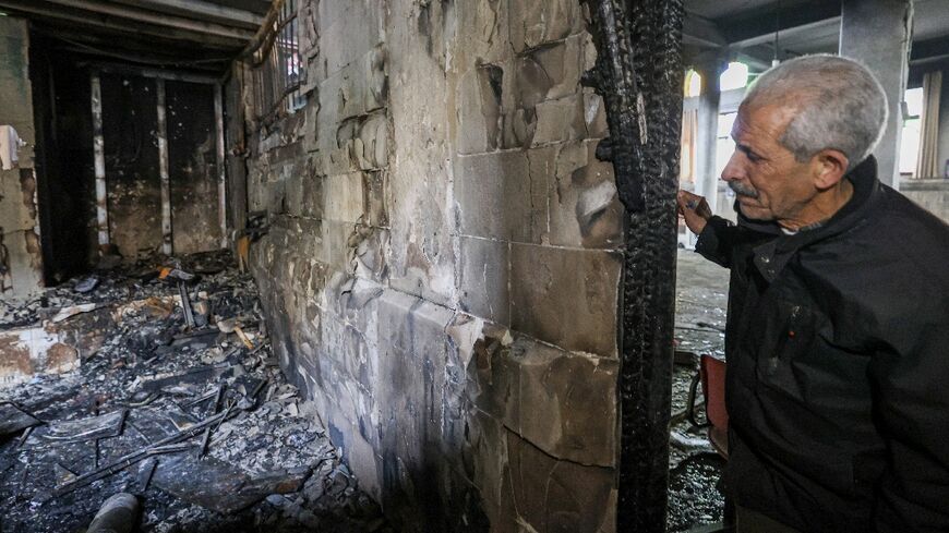 A Palestinian man checks the partially burned al-Nasr mosque in Nablus 