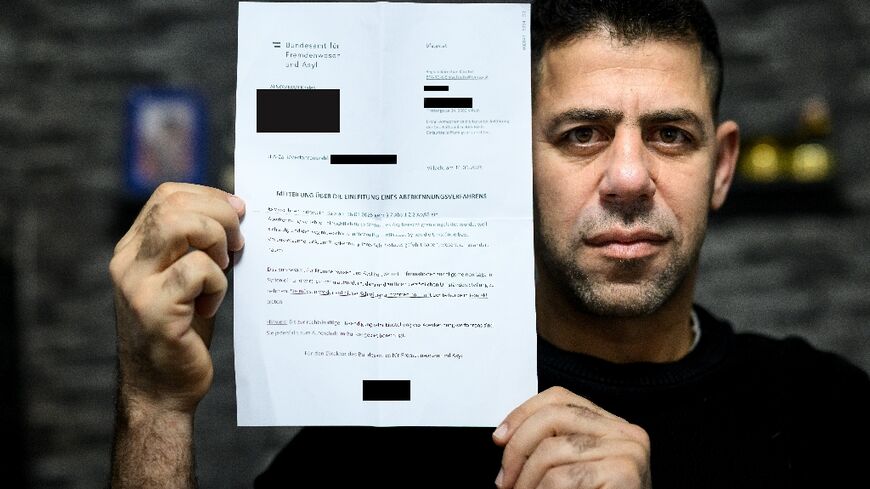 'What have we done?' Syrian refugee Khaled Alnomman with the letter threatening his family's asylum status