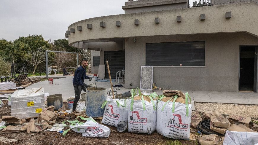 Builders renovate a house in Israel's northern kibbutz community of Hanita near the border with Lebanon