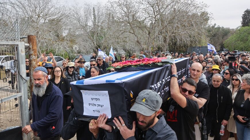 Hundreds of mourners came to pay their respects as Elgarat's black coffin topped with an Israeli flag was brought to Nir Oz on Monday