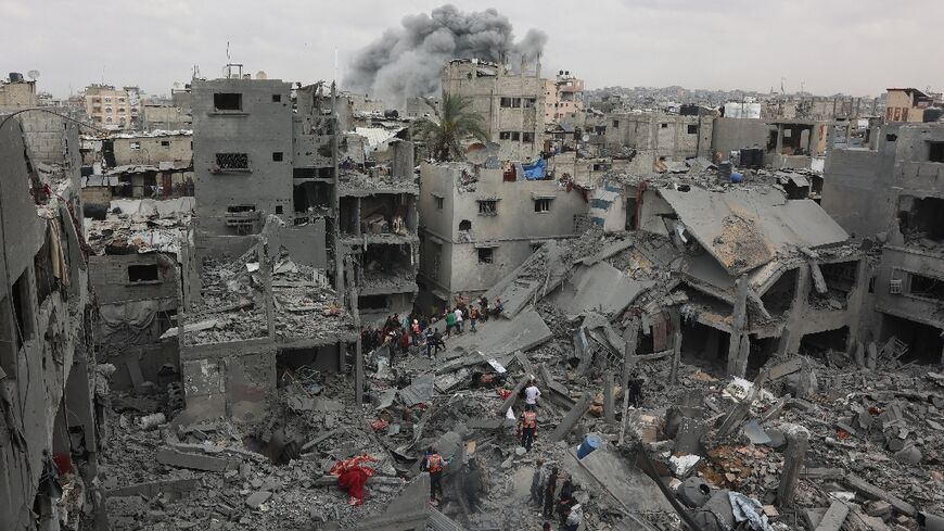 Palestinian rescuers search the rubble of a four-storey residential block in Gaza City for survivors after it was flattened by an Israeli strike, killing at least 23 people, according to the civil defence agency.