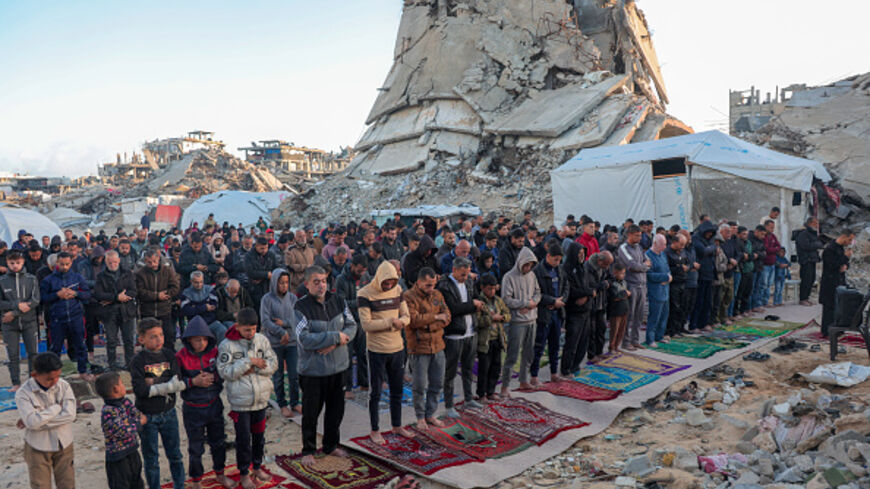 Palestinian Muslims say their Eid al Fitr prayers among the rubbles in Jabalia camp, north of the Gaza Strip on March 30, 2025. (Photo by Abood Abusalama / Middle East Images / Middle East Images via AFP) (Photo by ABOOD ABUSALAMA/Middle East Images/AFP via Getty Images)