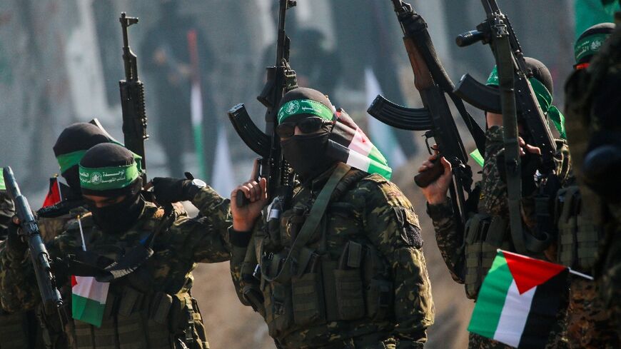 Hamas militants stand guard near a stage before releasing an Israeli hostage