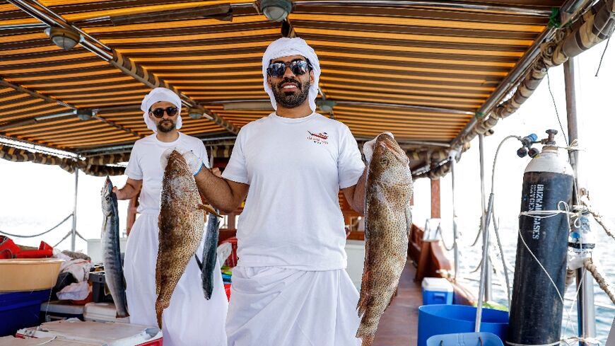 A Qatari contestant shows off his catch in a line-fishing competition that forms part of a festival aimed at reviving the emirate's sea-faring tradition.